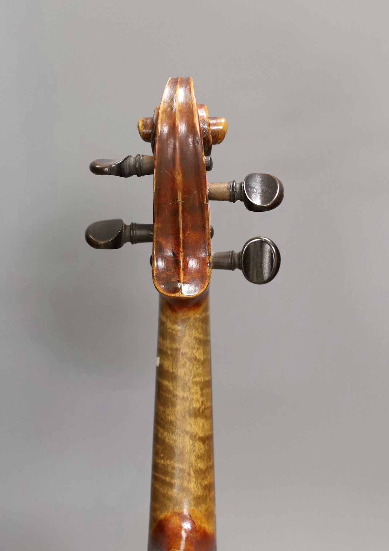 A quarter size late 19th century violin with bow, in E. Hill & Sons case, back measures 29cm